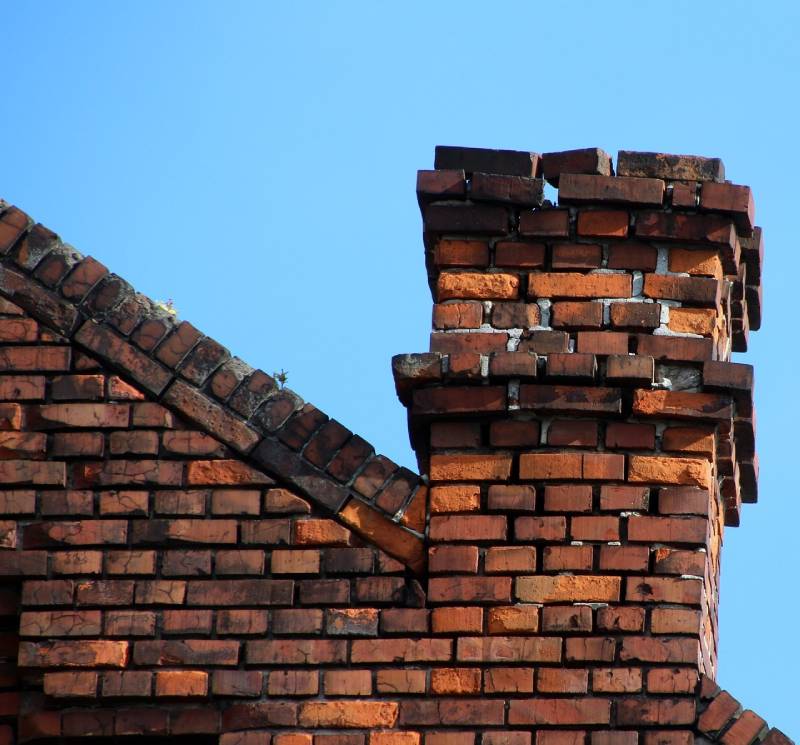 Damaged chimney on an Raynham home showing cracks and missing mortar